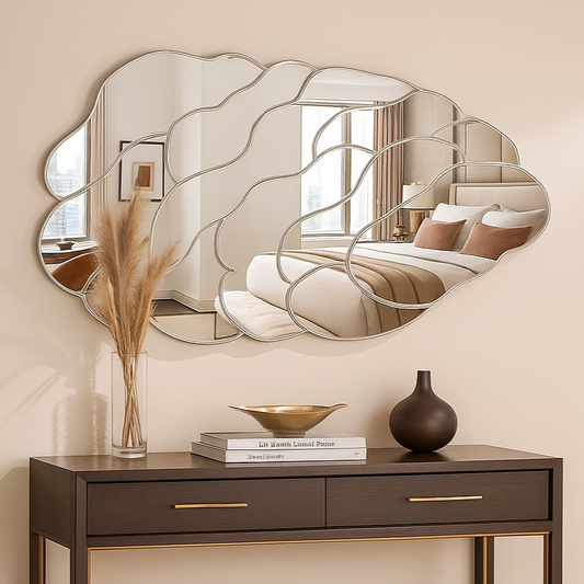 Decorative mirror with wavy design above a dark wooden console table.