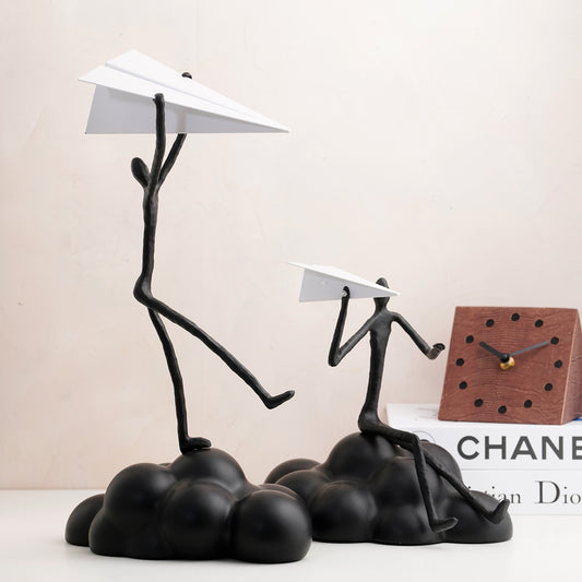 Decorative Black Human Figurines on a cloud with paper plane