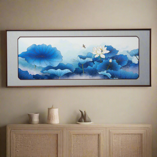 Luxury framed 3D artwork of blue flowers and white lotus on a beige wall above a wooden cabinet.