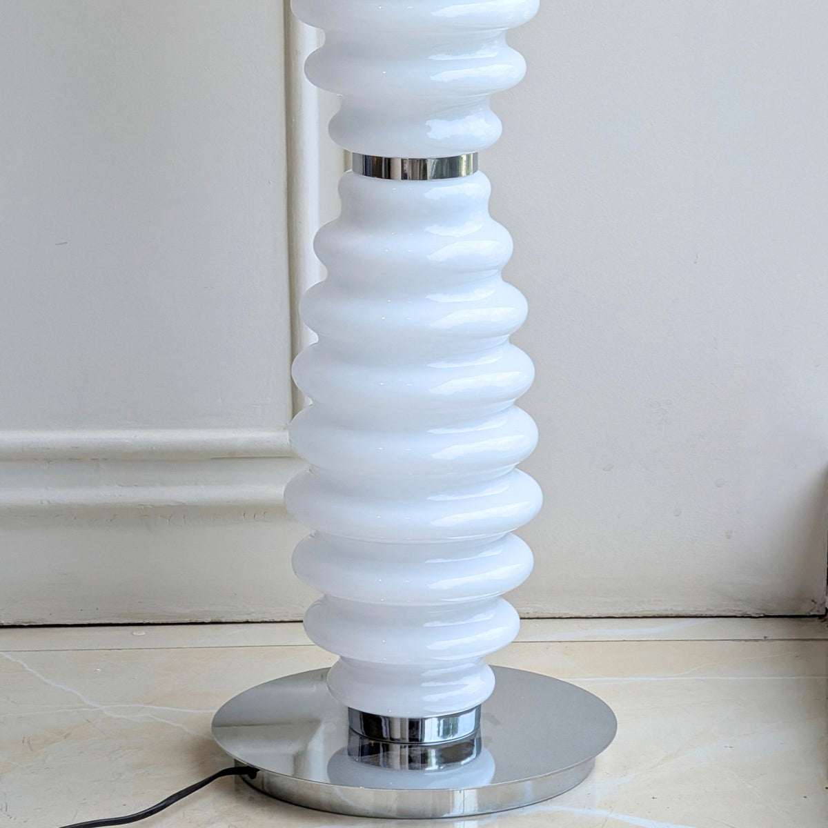 Close-up of Luma Totem ribbed glass and polished metal base