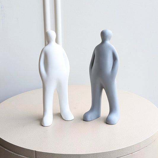 Off Duty minimalist resin standing figurines in White and Grey shown together