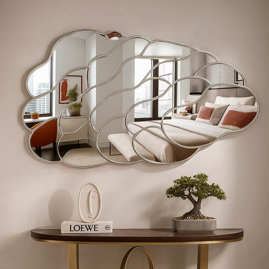 Decorative wall mirror with wavy design above a wooden console table in a room setting.