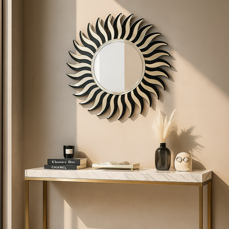 Decorative wall mirror with a sunburst design above a console table in a room.