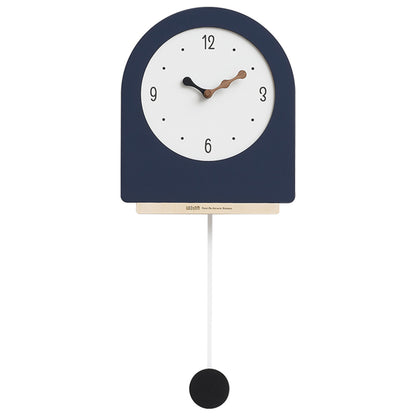 Navy blue wall clock with white face and black pendulum on a white background