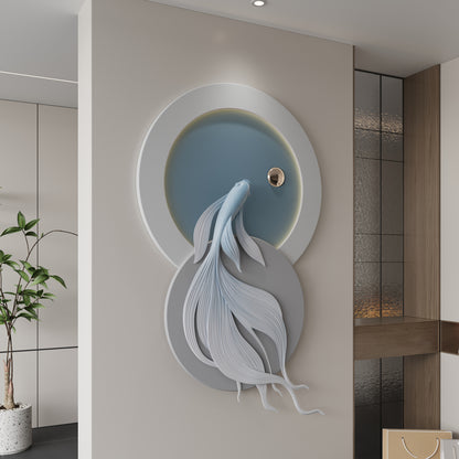 Decorative wall art of a fish in a circular frame on a wall.