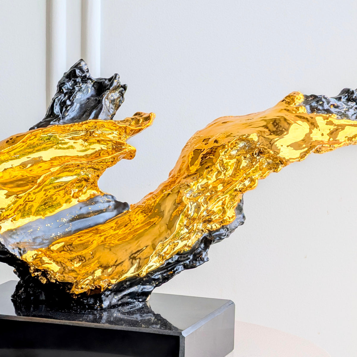 Ignis gold-toned and black sculptural resin textured detail