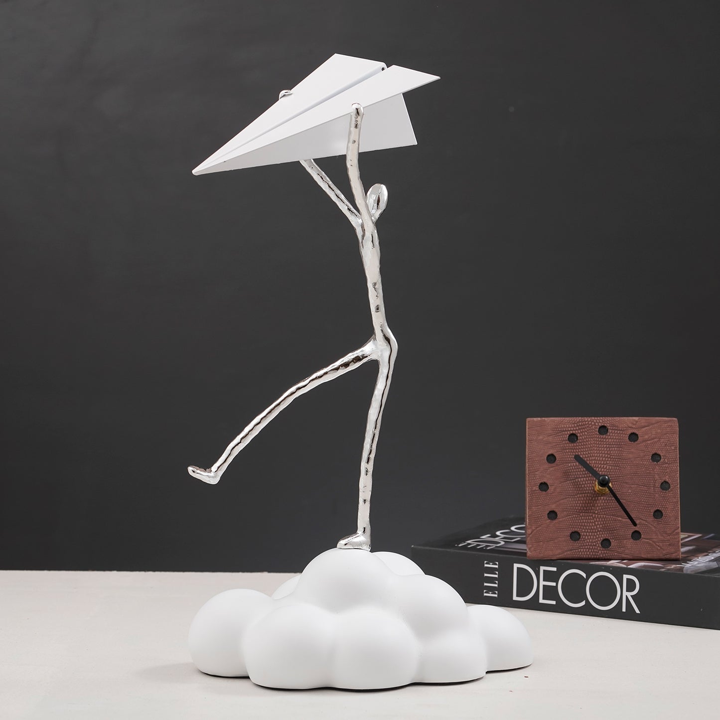 Decorative Human Figurine on a cloud holding a paper airplane in White & Silver