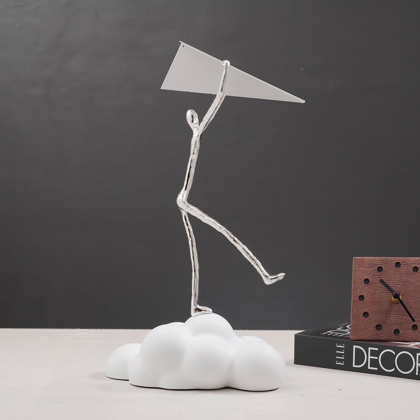 Decorative Human Figurine on a cloud holding a paper airplane in White & Silver