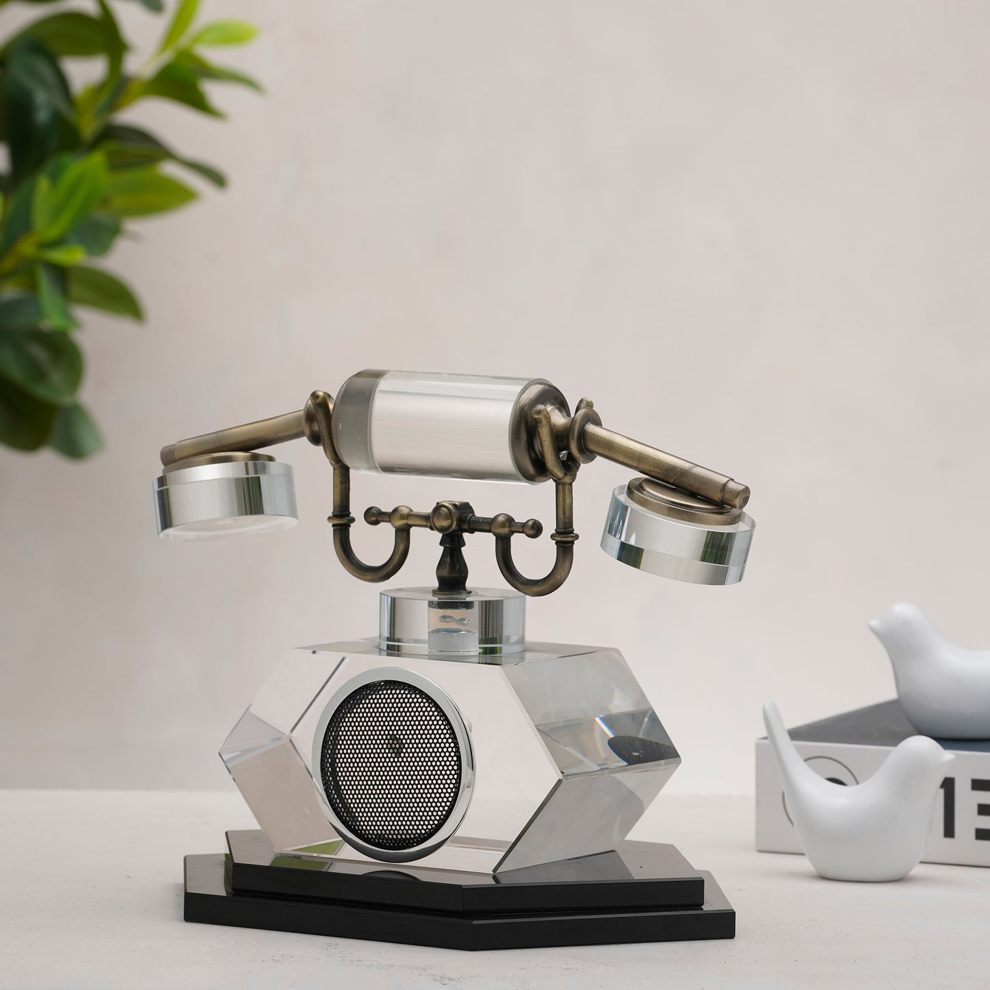 Decorative vintage-style phone on a table with a plant in the background