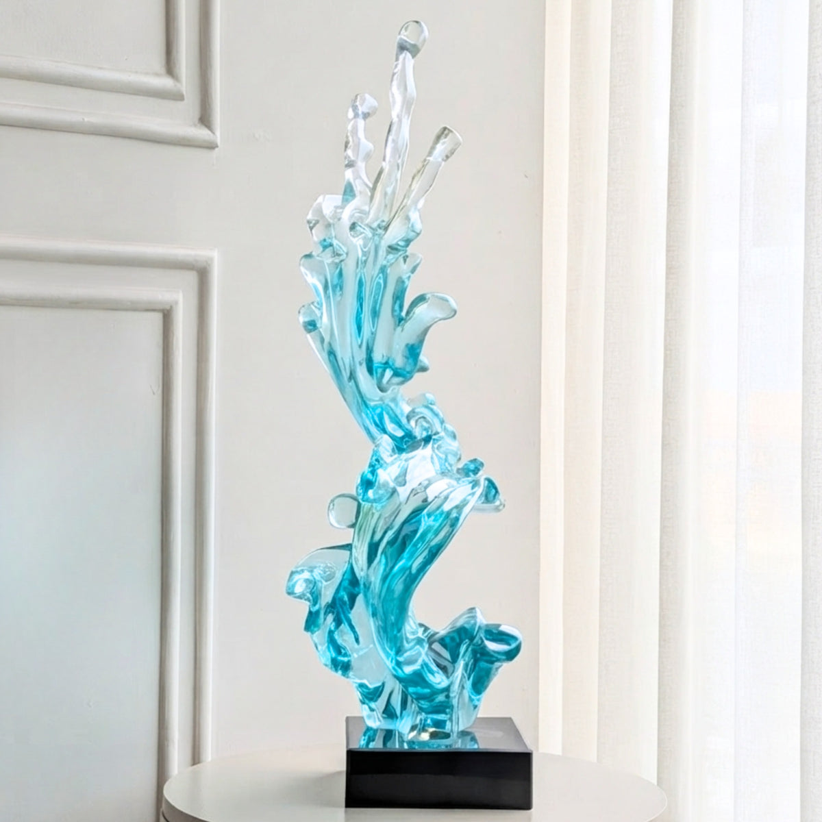 Aqua blue wave resin showpiece with black marble base, front view