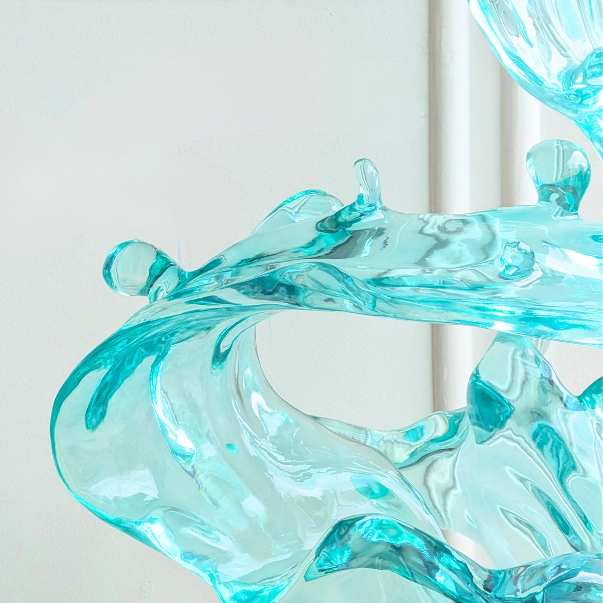Aqua blue resin wave sculpture, close-up detail