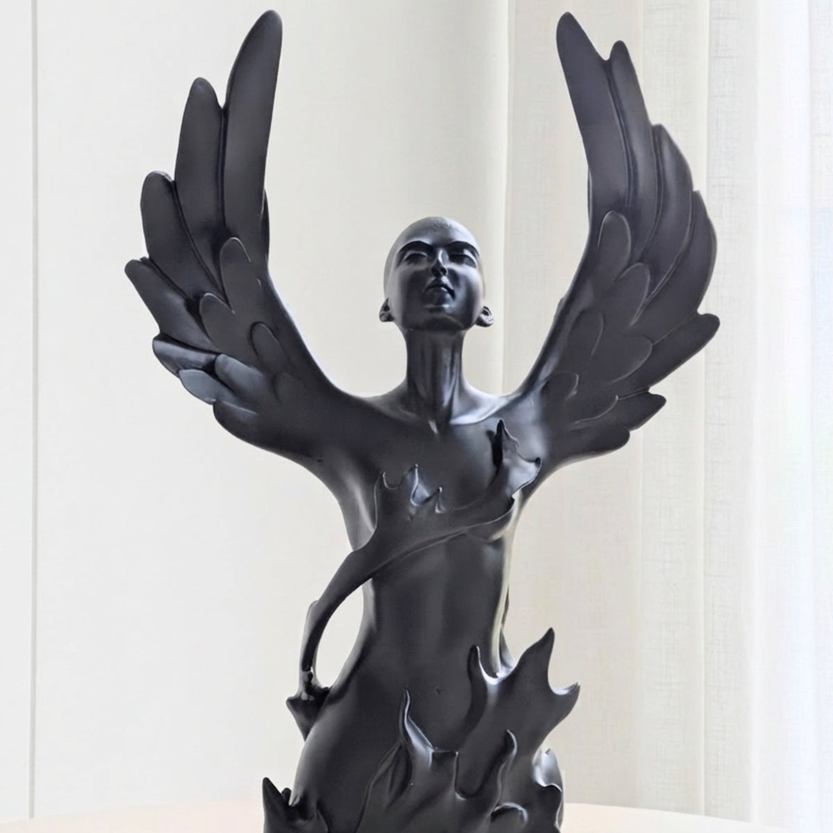 Close-up of Ascend winged human figurine with sculpted feather detailing