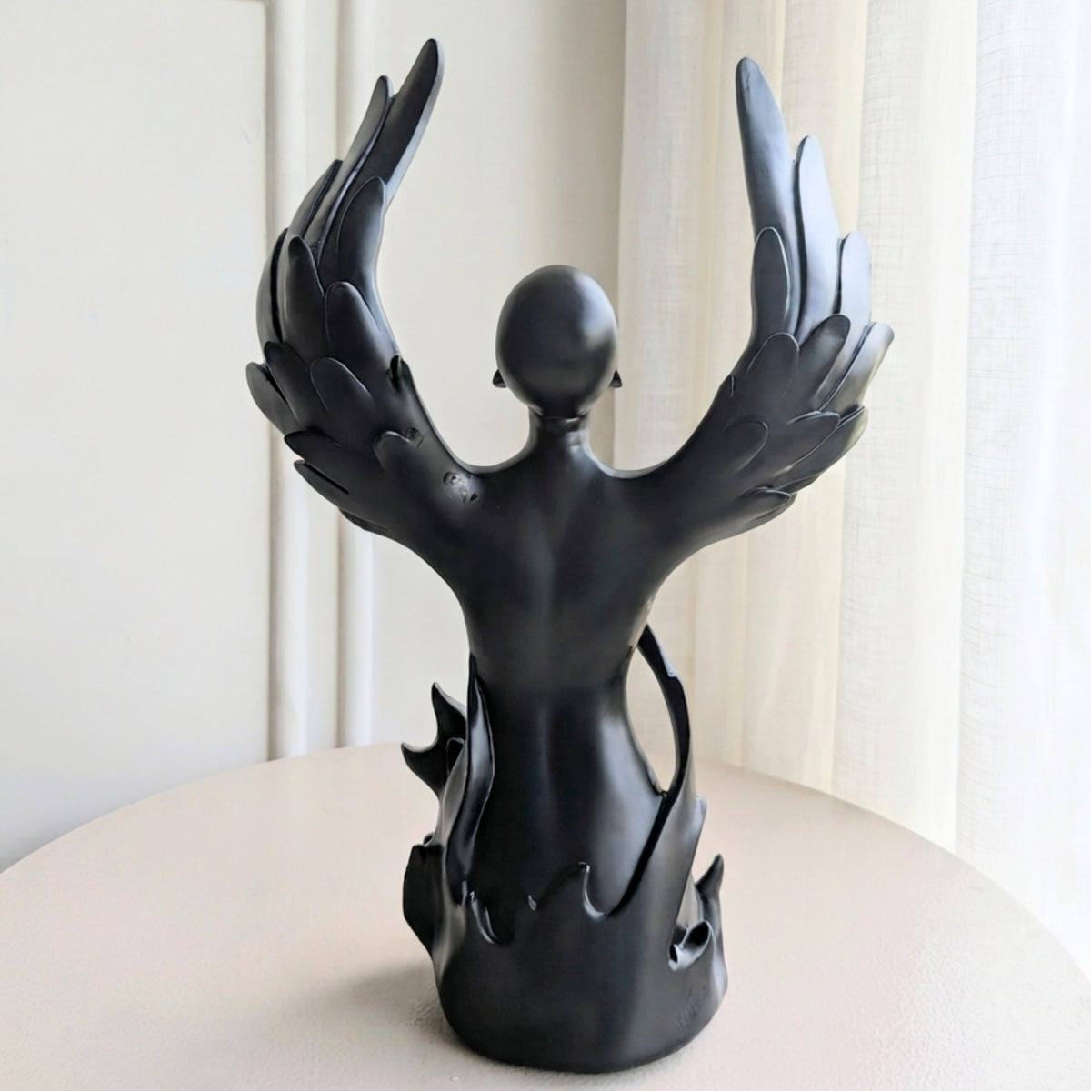 Back view of Ascend winged human showpiece in matte black resin