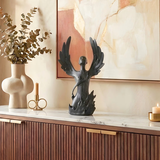 Ascend black resin winged human showpiece styled on a console table
