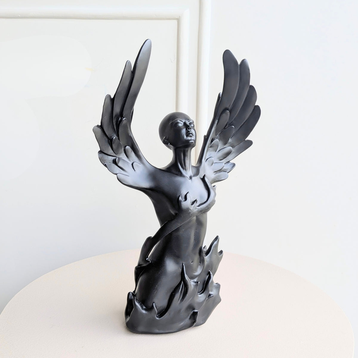 Front view of Ascend black resin winged human showpiece