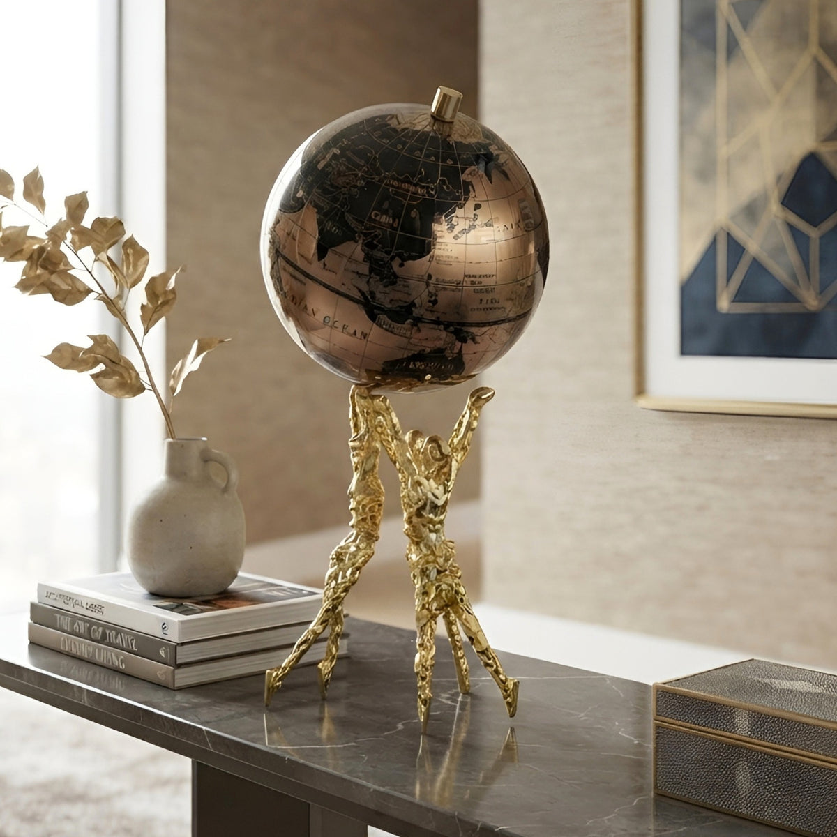 Atlas gold globe figurine styled on a modern console