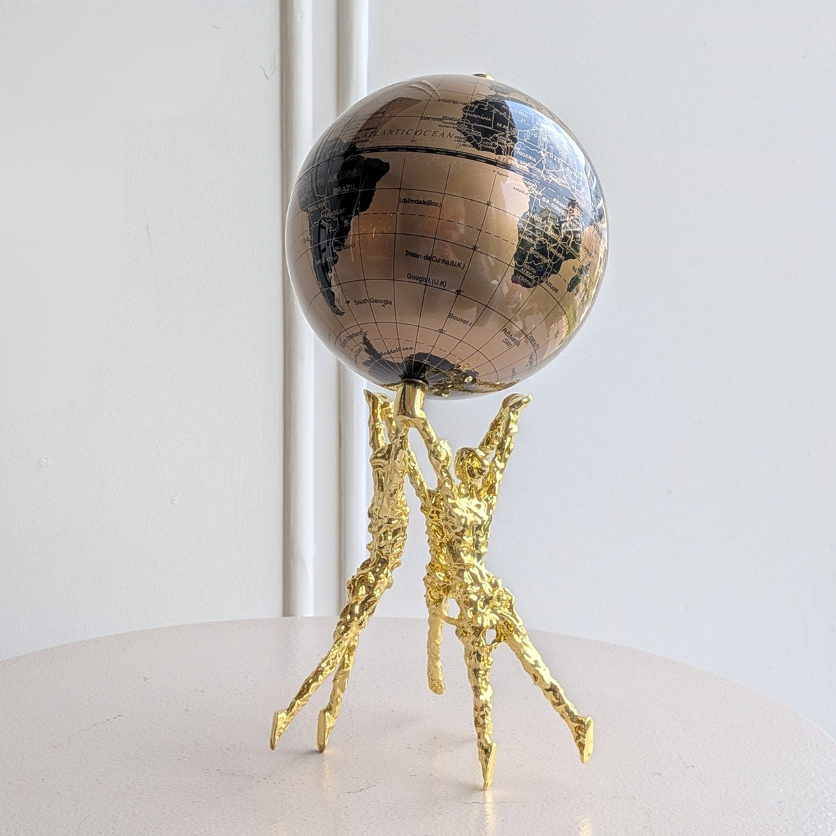 Atlas gold human figurine with bronze and black globe front view