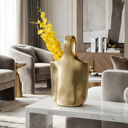 Aurea gold ceramic statement vase styled on a modern living room center table