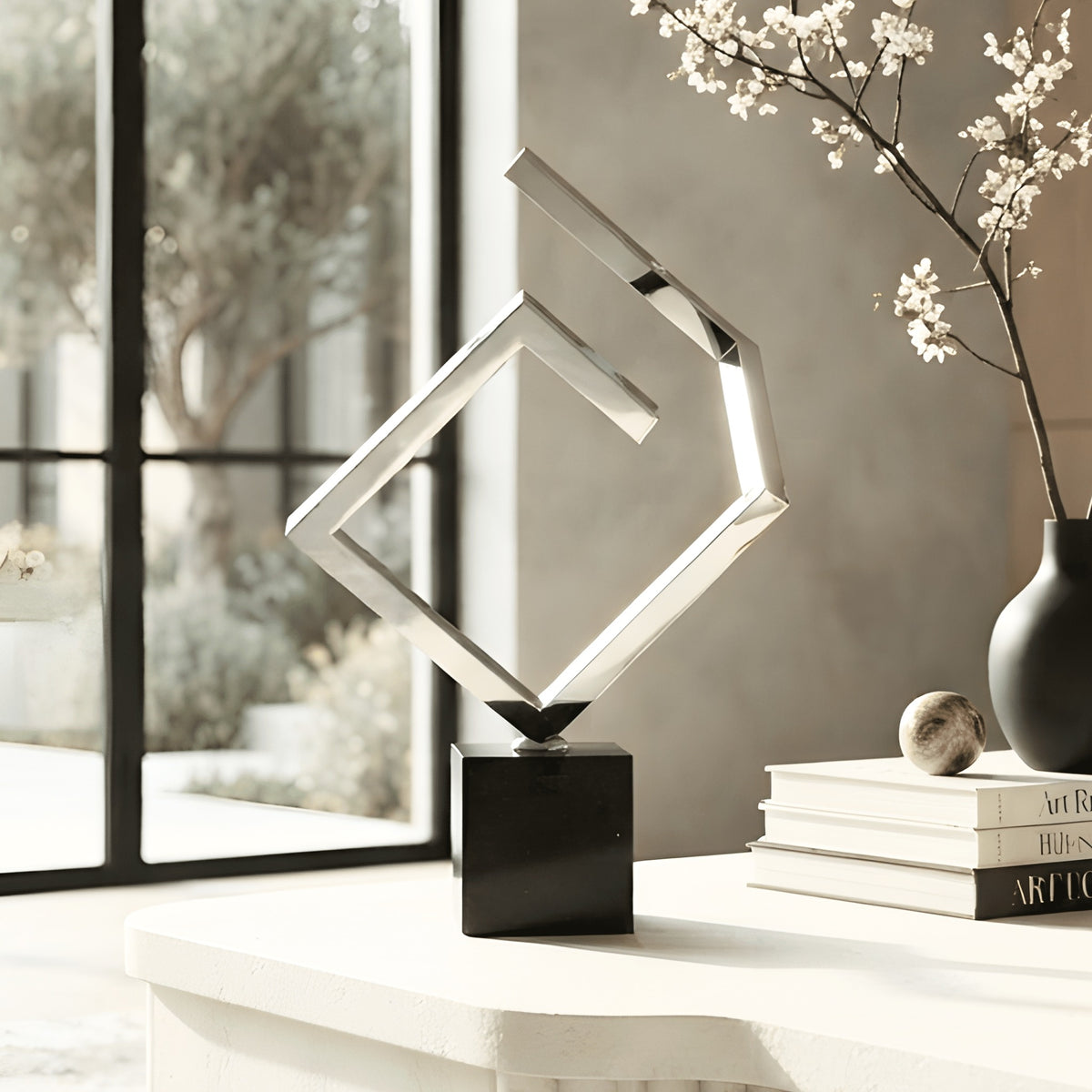 Axiom stainless steel and marble showpiece styled on an entryway console