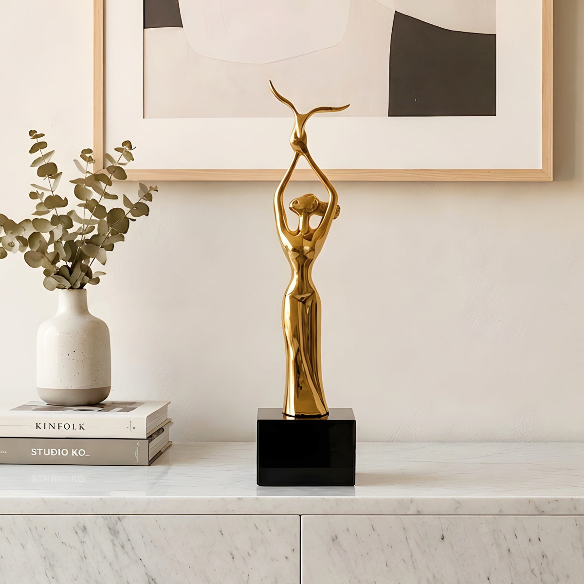 Ballet gold-toned metal lady figurine styled on a console table