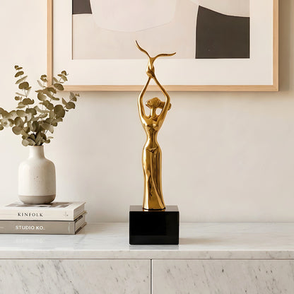 Ballet gold-toned metal lady figurine styled on a console table