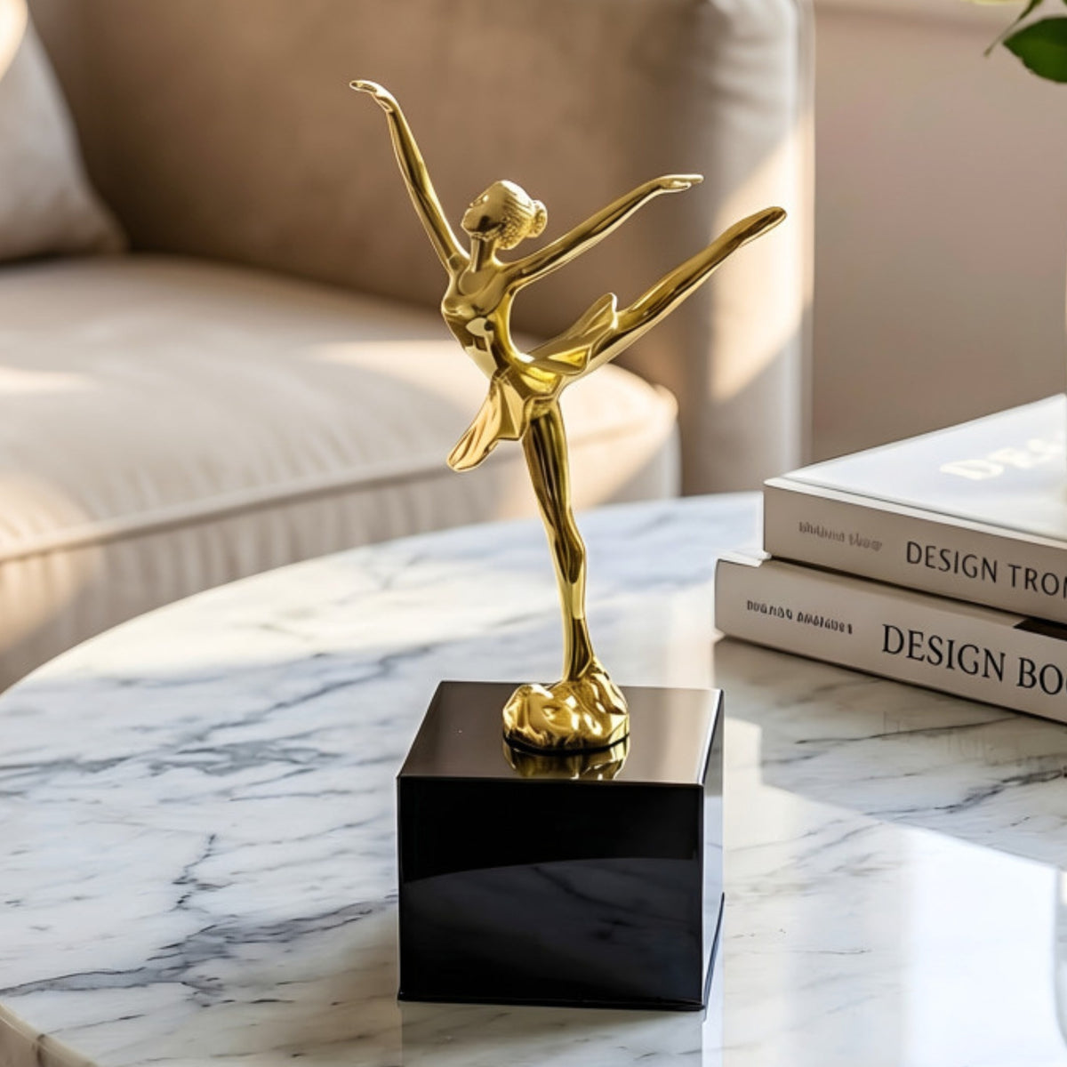 Ballet Style 2 gold metal lady figurine on black base styled on a marble coffee table