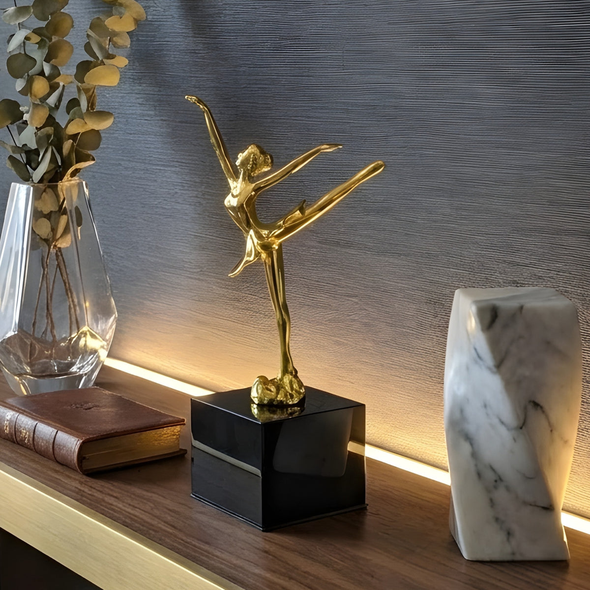 Ballet Style 2 gold metal ballerina showpiece styled on a dark wood console