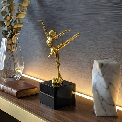 Ballet Style 2 gold metal ballerina showpiece styled on a dark wood console