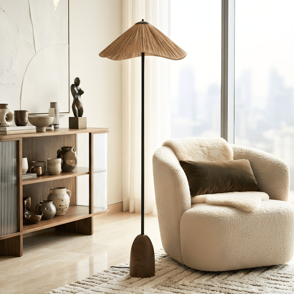 Canopy tall floor lamp beside a boucle reading chair in a bright living room corner