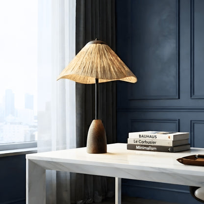 Canopy table lamp glowing on a console against a deep blue interior wall