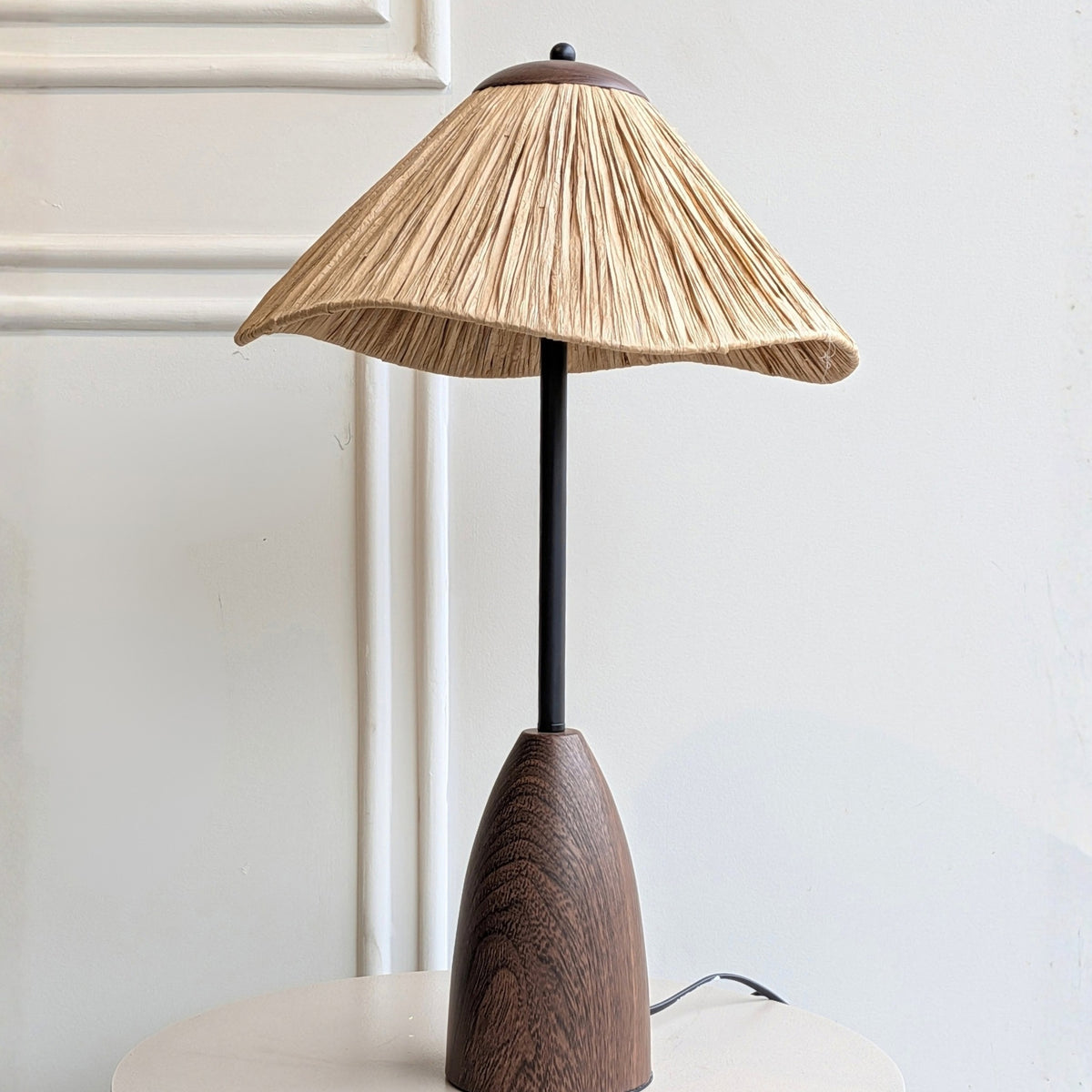 Canopy table lamp product view with warm wood-toned base, black stem and flared shade