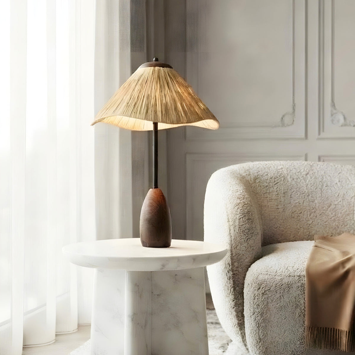 Canopy small table lamp styled beside a curved lounge chair on a marble side table