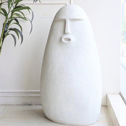 Carven large textured resin floor sculpture with a carved stone finish and abstract human face
