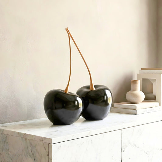 Cherish black resin and gold metal cherry showpiece styled on a modern console table