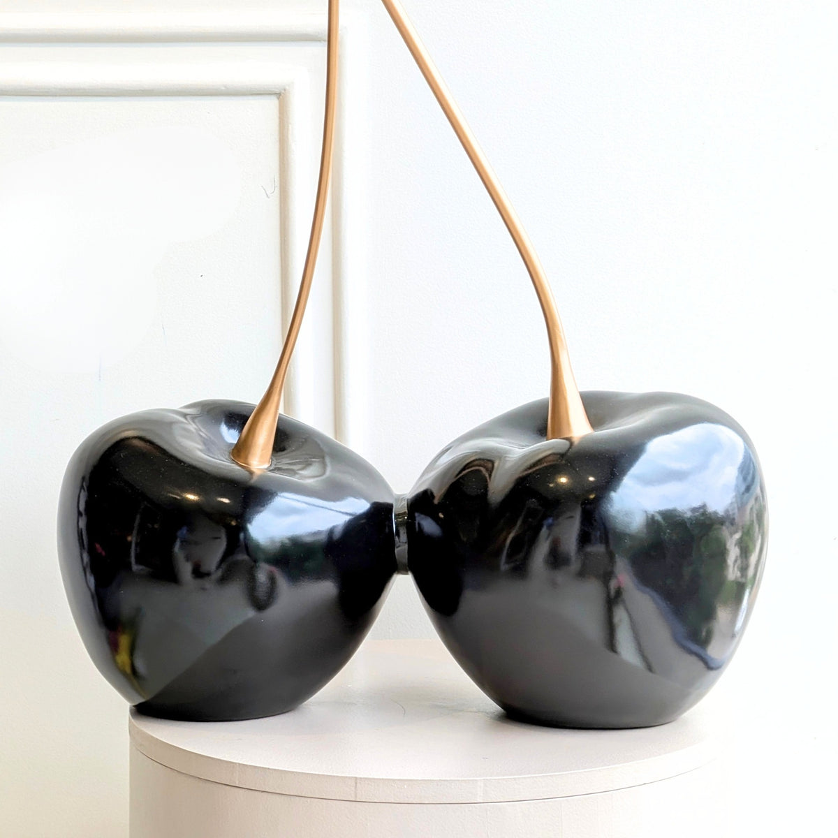 Cherish glossy black resin cherry showpiece with gold metal stems front view