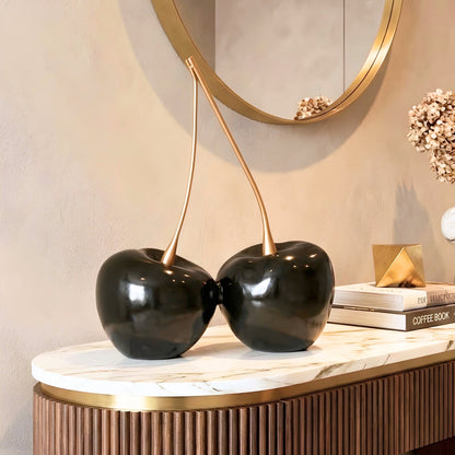 Cherish oversized black cherry sculpture with gold stems styled on an entryway console