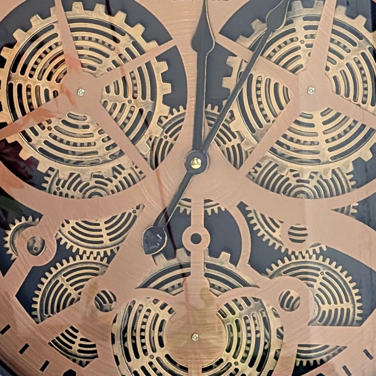 Close-up detail of Chronicle metal and glass vintage gear wall clock