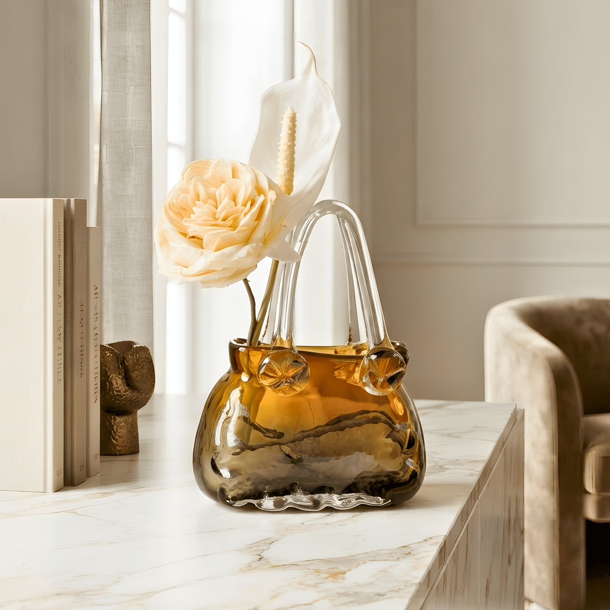 Couture amber crystal handbag vase styled with flowers on a marble console