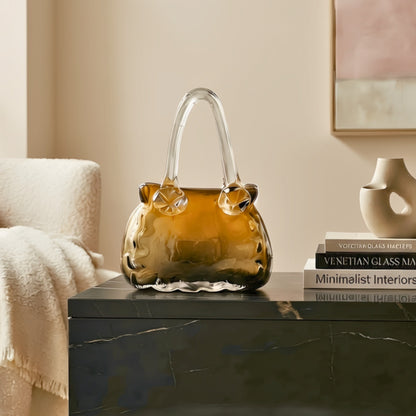 Couture amber crystal handbag vase styled on a black console in a modern living room