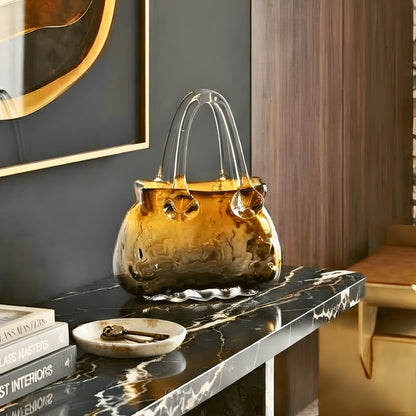 Couture amber crystal handbag vase styled on a black marble entryway console