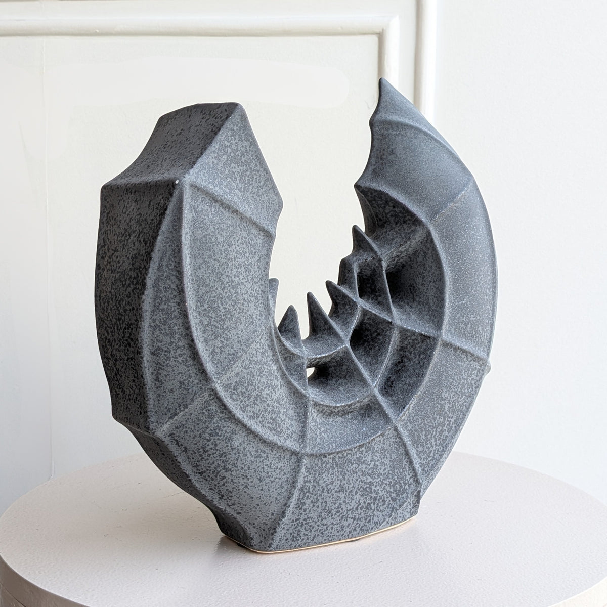 Crescent ceramic vase and showpiece angled studio view