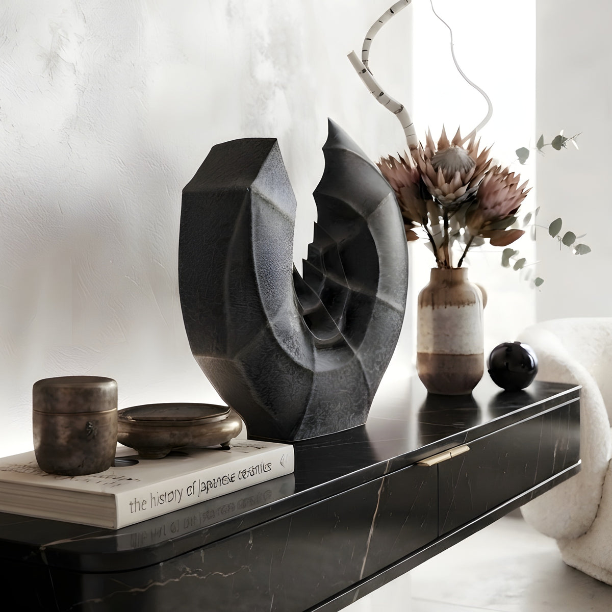 Crescent ceramic vase and showpiece on a console table