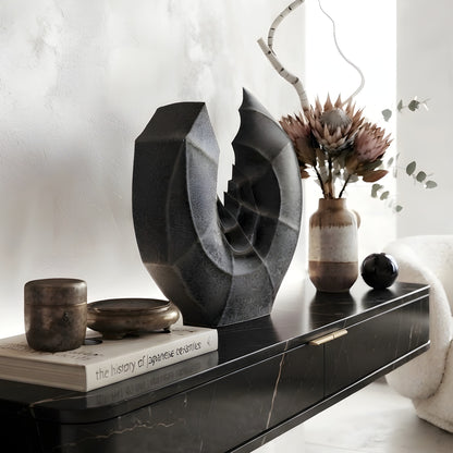 Crescent ceramic vase and showpiece on a console table