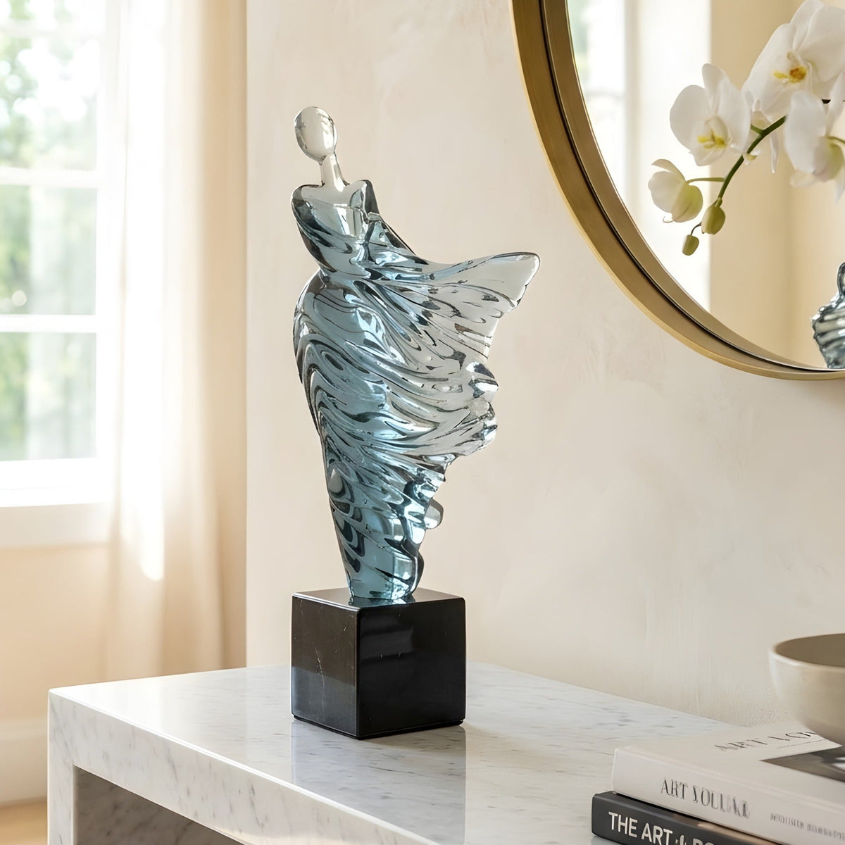 Diva translucent blue dancer showpiece styled on an entryway console beneath a round mirror