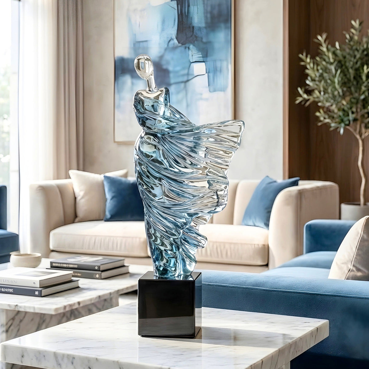 Diva tall blue resin dancer sculpture styled on a marble side table in a luxury living room