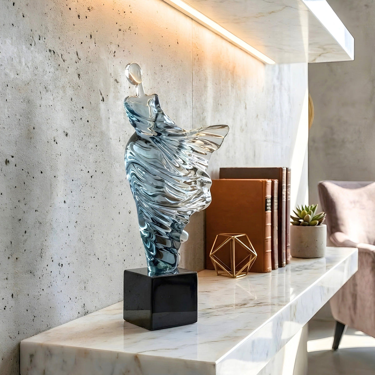 Diva resin dancer showpiece on an illuminated marble shelf with books and decor