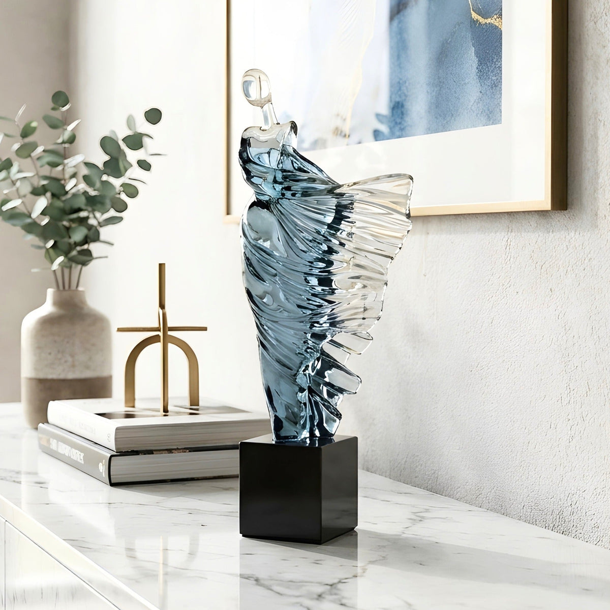 Diva flowing dancer figurine styled on a marble sideboard with books and modern decor