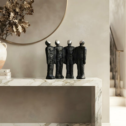 Ensemble four connected human figures as statement decor beneath a round entryway mirror