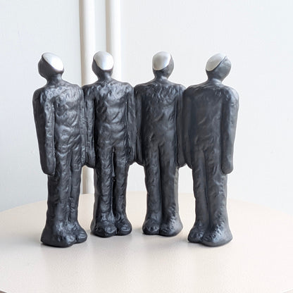 Ensemble charcoal-black abstract resin figurines with sculpted textured finish and pale faces