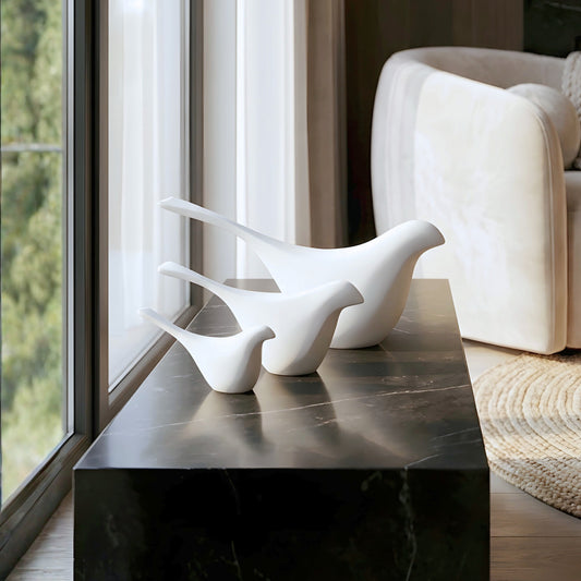 Flock white bird showpieces set of 3 styled on a black marble console in a modern living room